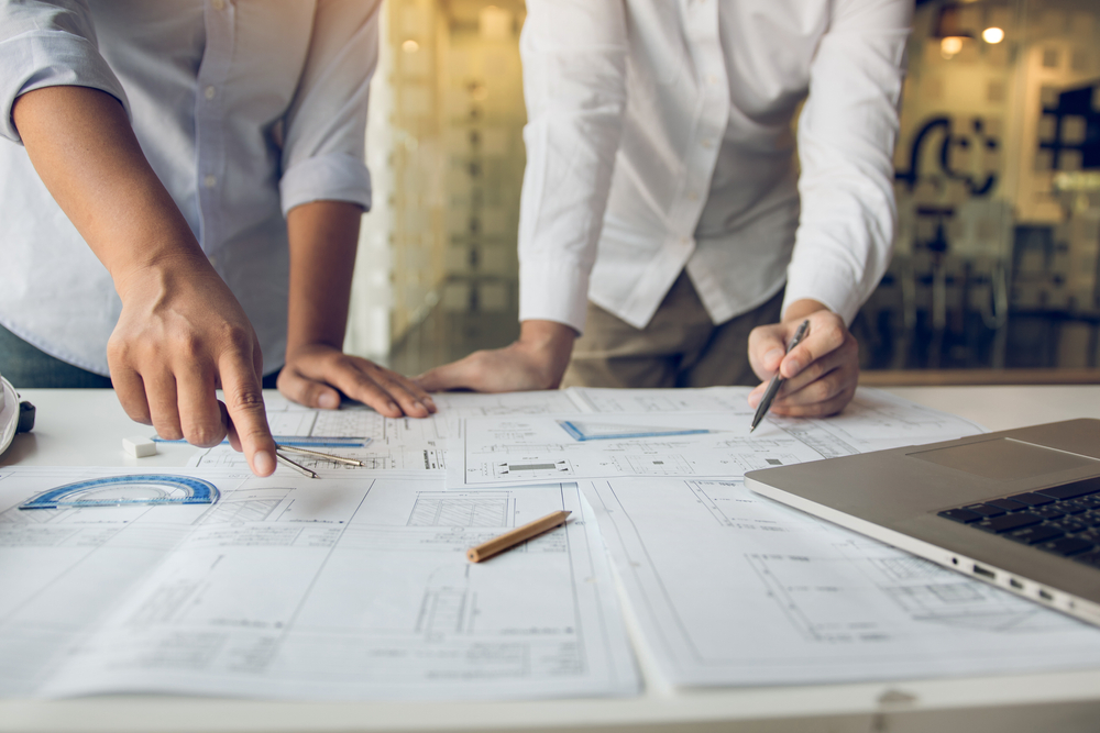 Engineers,Are,Helping,To,Design,Work,On,Blueprints,And,Collaborate Engineers,Are,Helping,To,Design,Work,On,Blueprints,And,Collaborate