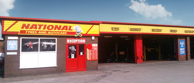 National Tyres and Autocare store exterior with bright yellow and red signage
