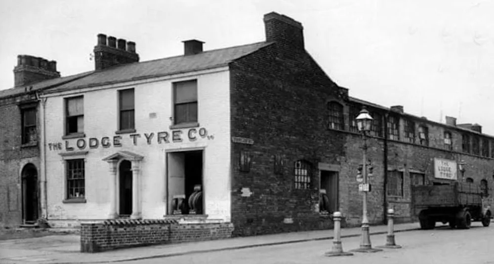 Historic black-and-white photograph of The Lodge Tyre Co building