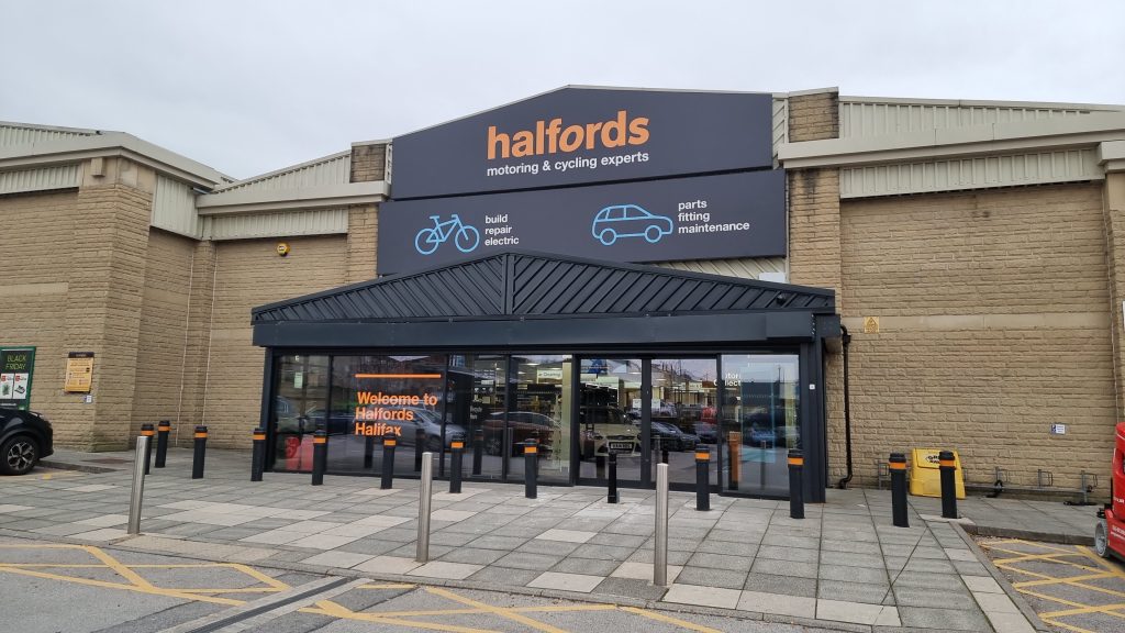 Exterior of a Halfords store with signage for motoring and cycling experts