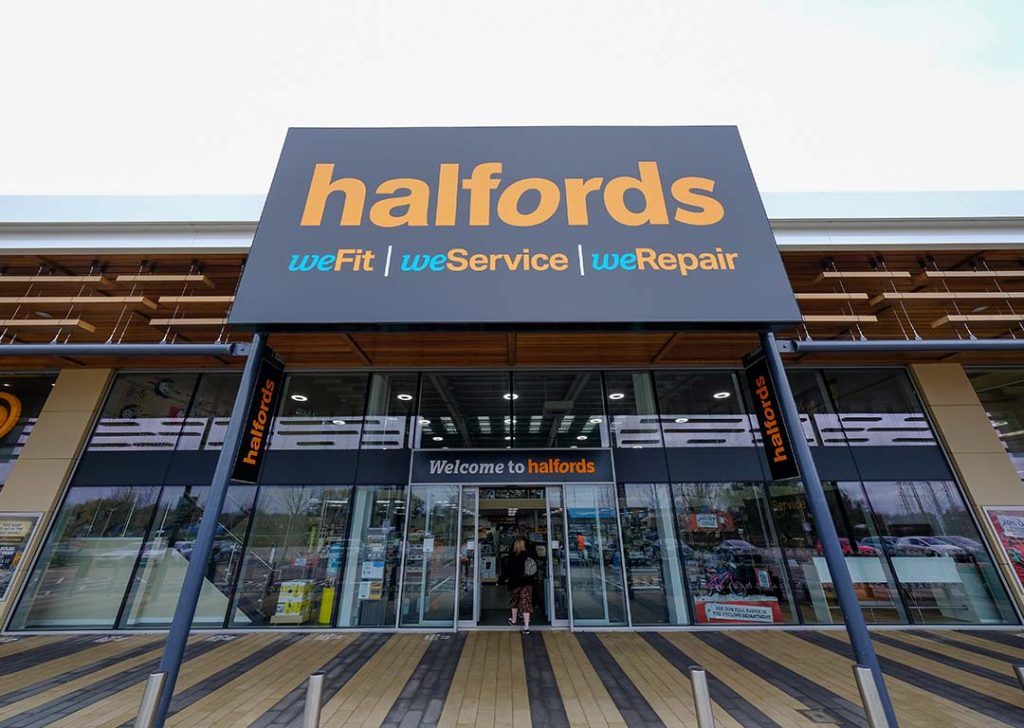 Front of Halfords store with signage 'weFit weService weRepair' and 'Welcome to Halfords'