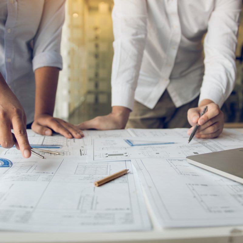 Engineers,Are,Helping,To,Design,Work,On,Blueprints,And,Collaborate Engineers,Are,Helping,To,Design,Work,On,Blueprints,And,Collaborate